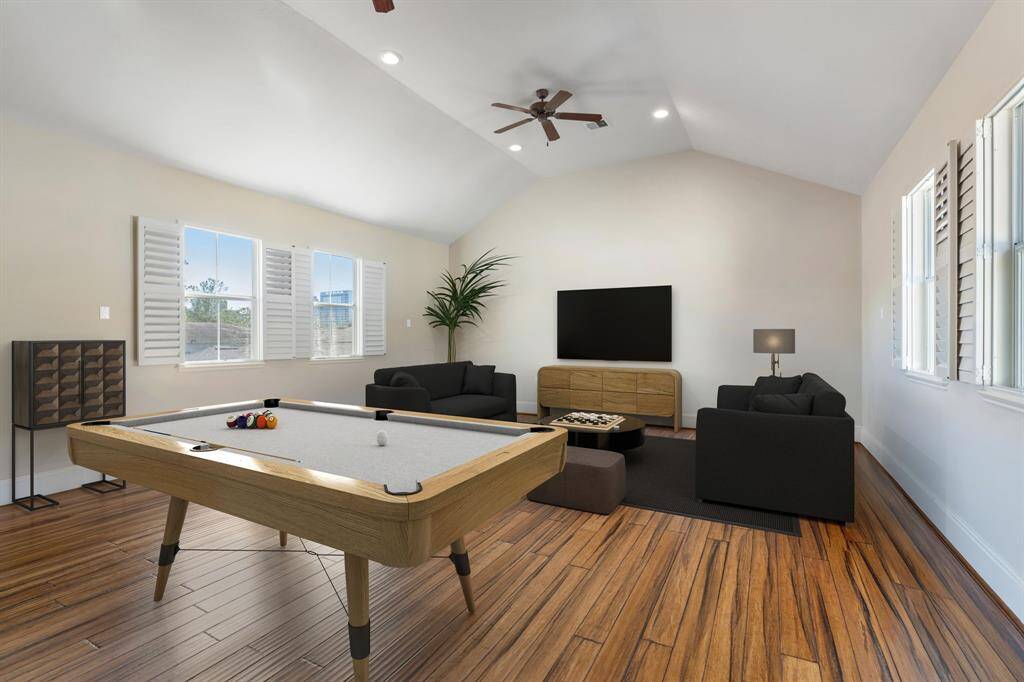 Located upstairs, this massive GAME ROOM with a vaulted ceiling offers endless possibilities. It could function as a game room, office, media room, home gym, or a mix of all! The room features hardwood floors, two ceiling fans, and recessed can lighting for comfort and style. Plantation shutters allow natural light while maintaining privacy. For added convenience, there’s a huge walk-in closet plus two additional closets for extra storage. Note: This room has been virtually staged.