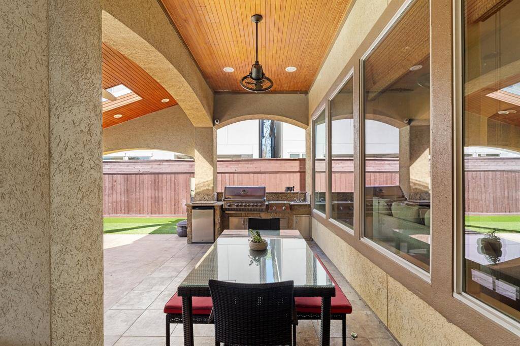 Fabulous summer kitchen equipped with a built-in grill, griddle, mini fridge and sink, perfect for cooking out!