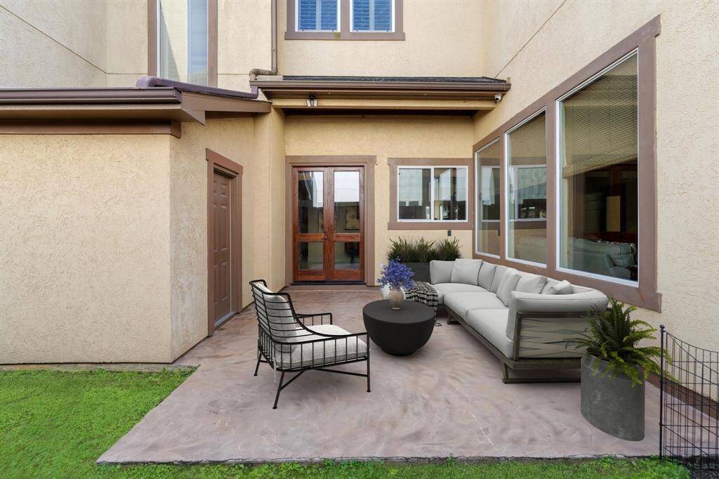This side patio, located just off the entryway/bar area, was added in 2020. Spacious patio offers plenty of room for outdoor furniture, perfect place to enjoy the fresh air! Note: this photo has been virtually staged.
