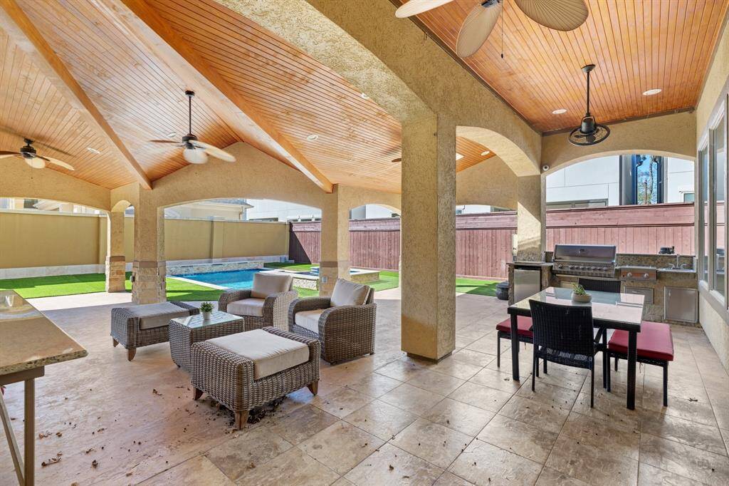 This expansive covered patio, added in 2017, offers the perfect space for outdoor living and entertaining. Features ceiling fans, recessed can lights, and ceiling speakers for added comfort and ambiance. With tons of space for outdoor dining and furniture, plus a summer kitchen, this patio is ideal for hosting gatherings or relaxing in style.