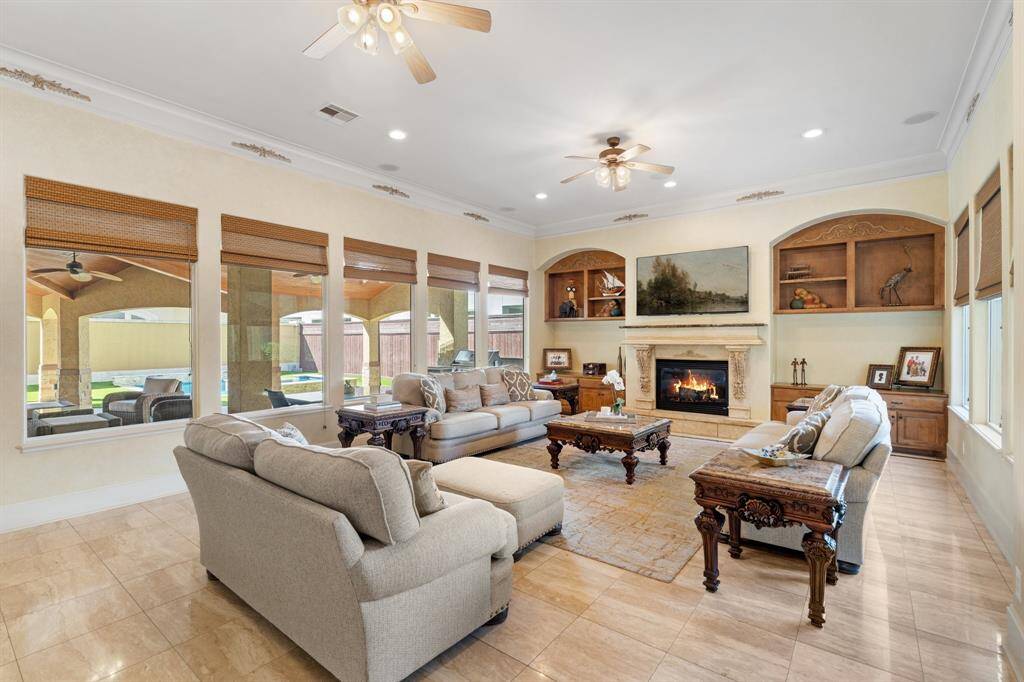 Another angle of this spacious family room showing the wall of windows overlooking the incredible covered patio and backyard.