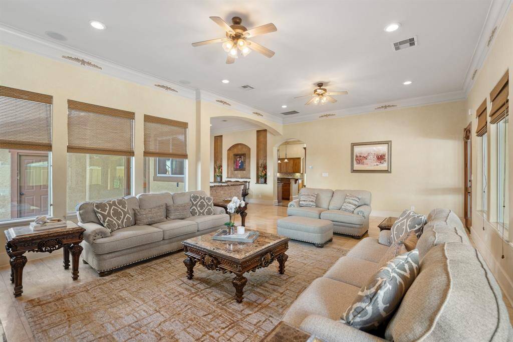 Another view of the family room looking towards the bar and kitchen. This room is flooded with natural light and offers so much space!