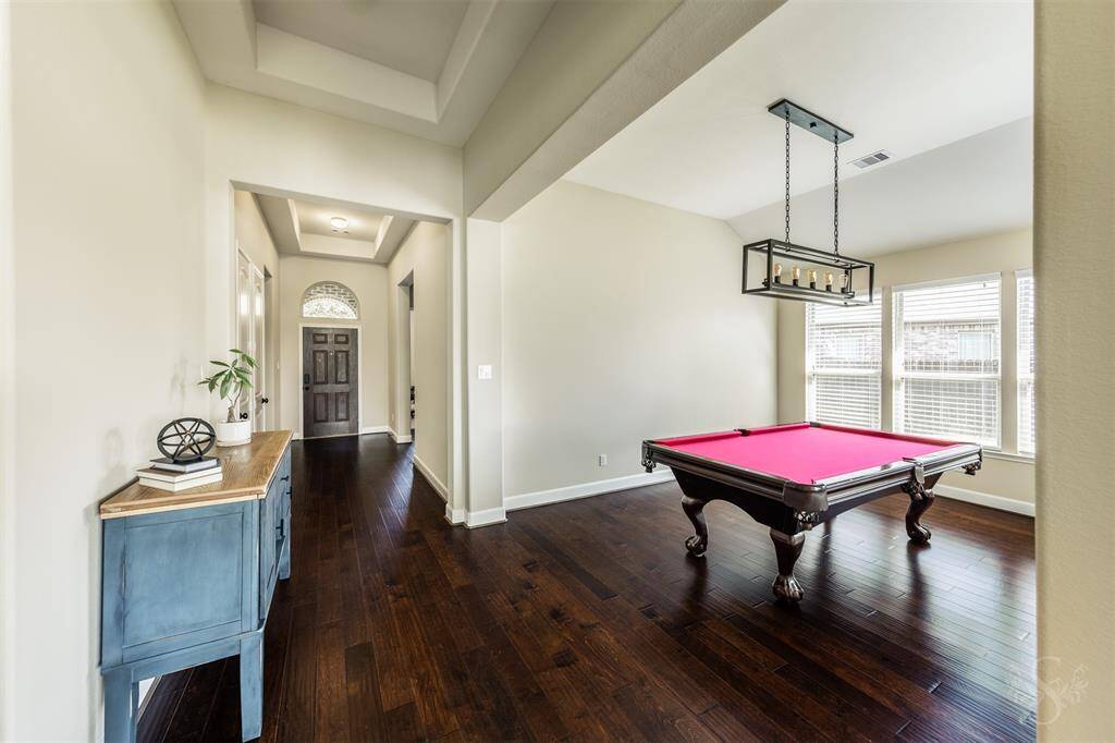 This is the dining room featuring a trio of windows and updated light fixture.