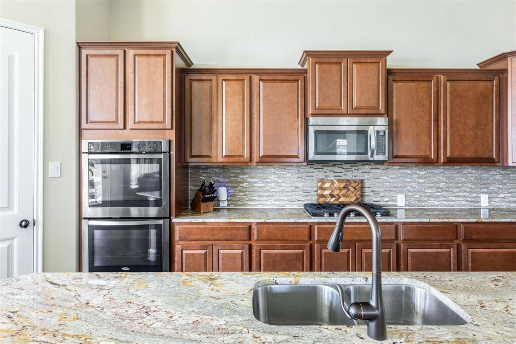 Beautiful, rich wood cabinets provide plenty of space for kitchen things.