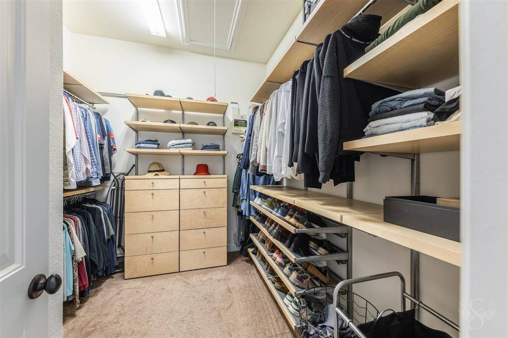 Custom built storage in Primary closet.  Makes it easy to manage your belongings.