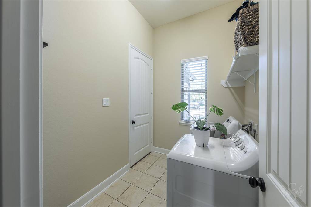 Utility room on way to garage.  Great stop on the way in from garage.  Washer and dryer are included.