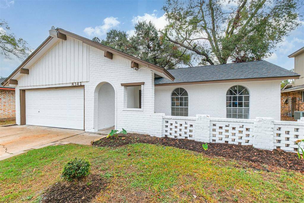 A covered front porch and an enclosed front patio enhance the home's appeal and functionality.
