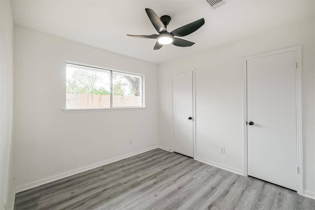 Bedroom #2 With ceiling fan and light fixture.