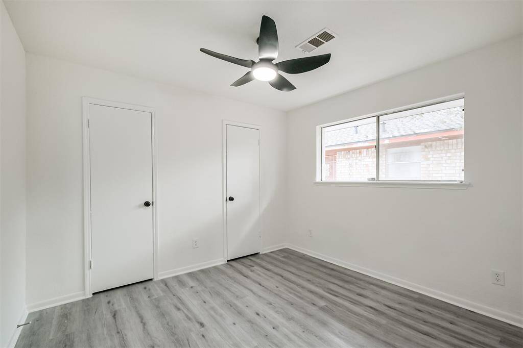 Bedroom #3 with ceiling fan and light fixture.