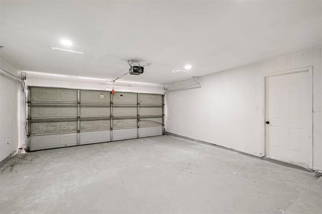 A two-car garage featuring an automatic door opener.