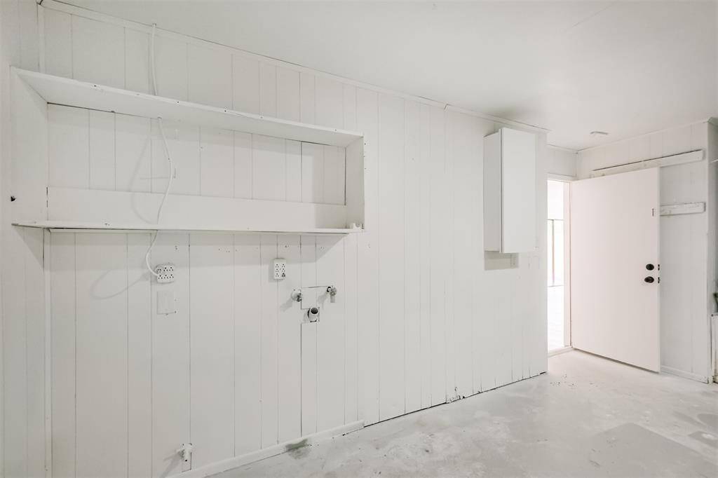 Utility room in the garage with washer and dryer connections.