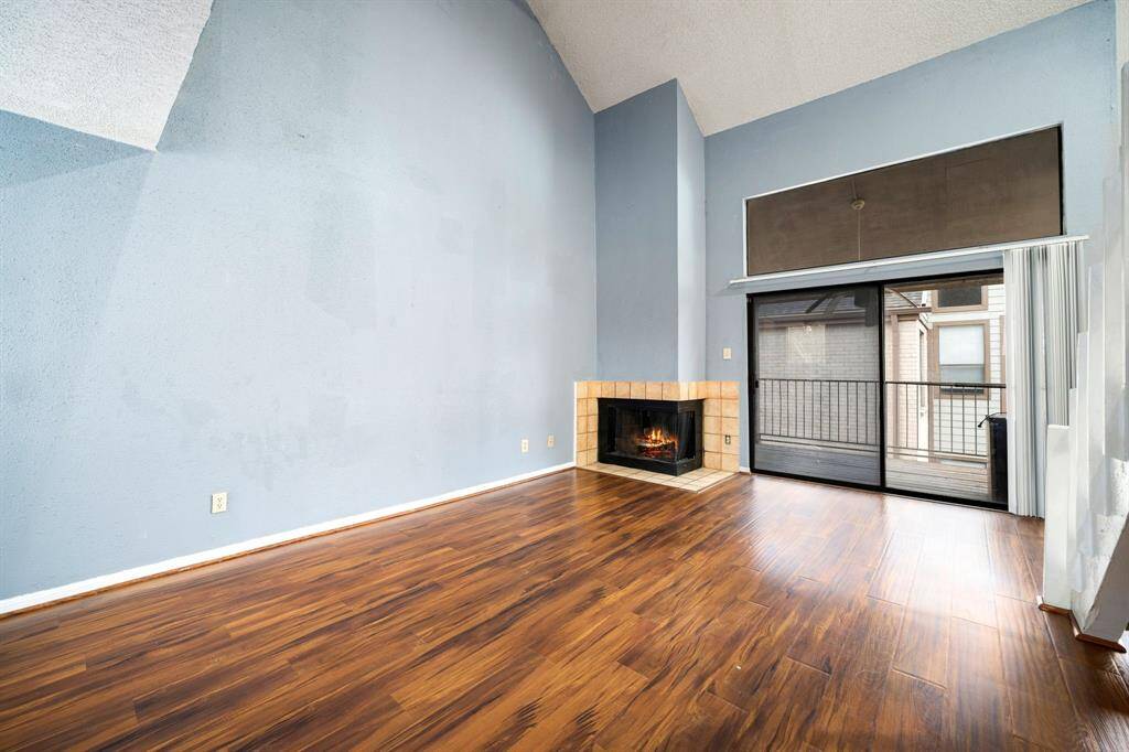 Large sliding glass doors open to a balcony, bringing in natural light.