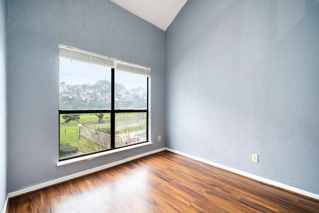 Featuring light blue walls and rich wood flooring.