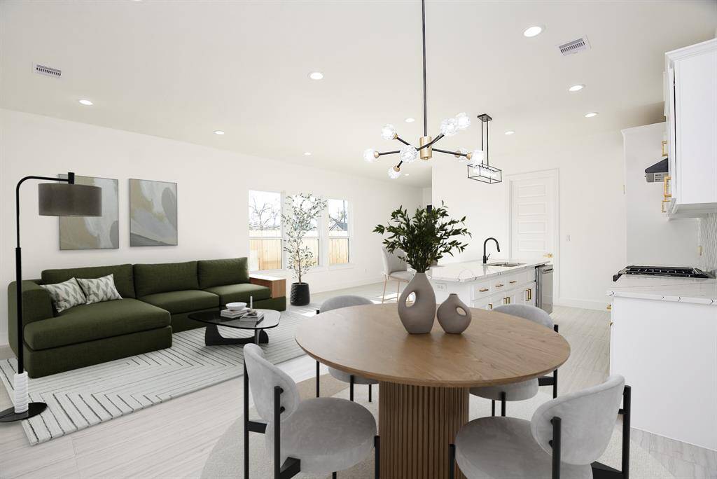 This open-concept kitchen and dining area boasts gleaming luxury laminate floors and abundant natural light from expansive windows. With ample space for any dining setup, it's the perfect blend of elegance and functionality for effortless entertaining.