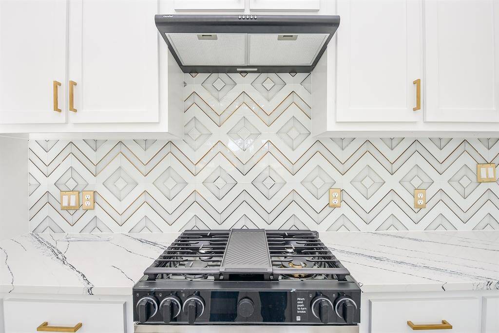 This stunning kitchen island features a sleek quartz waterfall countertop, a deep stainless steel double sink, and a modern black faucet. Perfect for meal prep, entertaining, and everyday living!