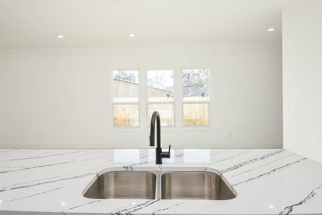 Retreat to this elegant primary suite, featuring soaring tray ceilings and tall windows that fill the space with natural light. Located on the first floor for added comfort and privacy, this serene sanctuary is the perfect place to unwind.