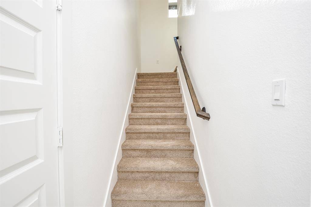 Step into this inviting second-floor game room, featuring plush carpeting and abundant natural light. With direct access to a private balcony, this versatile space is perfect for entertainment, relaxation, or family gatherings.