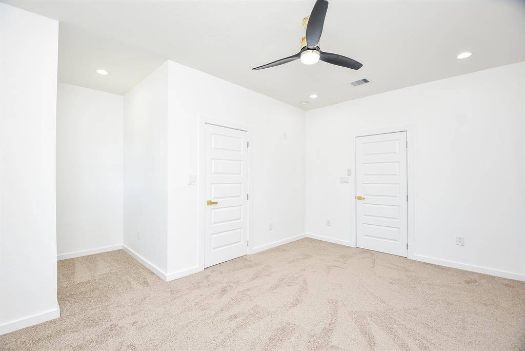 This well-appointed laundry room offers ample storage with built-in cabinets and drawers, plus a spacious quartz countertop for easy folding. A functional and stylish space designed for convenience.