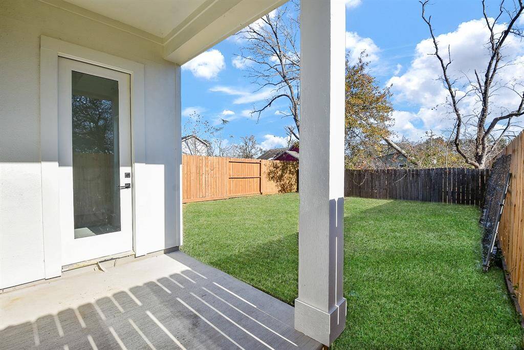 Relax and unwind in this serene backyard oasis, featuring a pristine lawn and a fabulous covered patio—perfect for outdoor dining and entertaining.