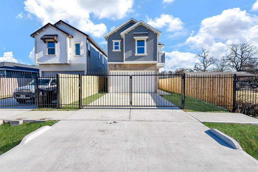 This modern entryway features a sleek walkway leading to a stylish glass-panel front door. The combination of brick and contemporary design elements creates a warm yet sophisticated curb appeal.