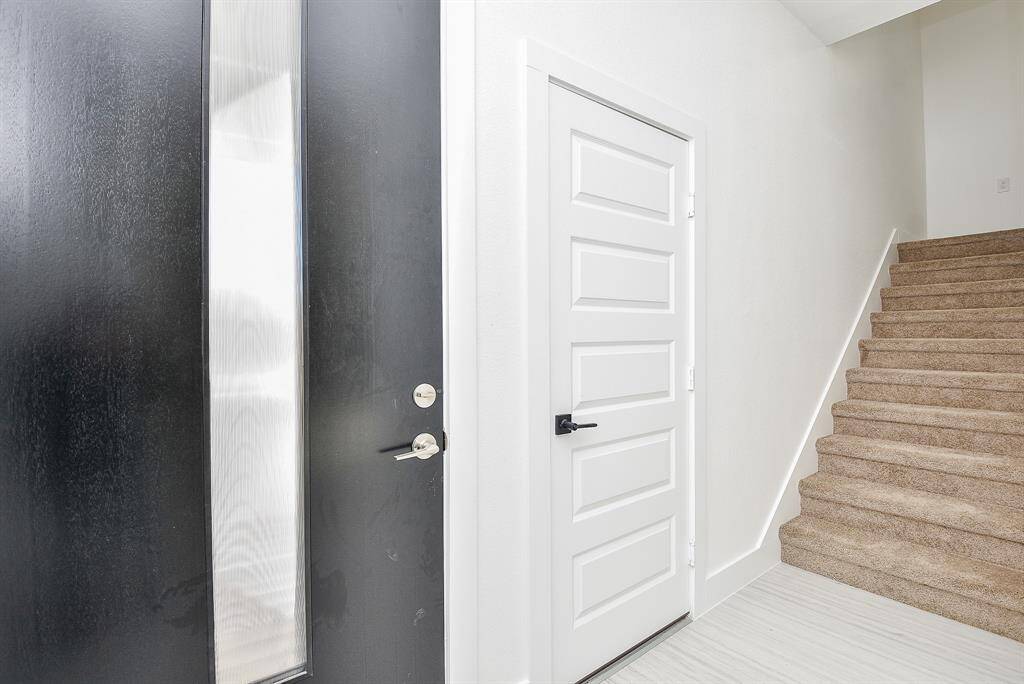 Elegant and modern, this powder room features a sleek quartz vanity with bold veining, complemented by luxurious gold fixtures. Bright and airy, its timeless design exudes sophistication and style.
