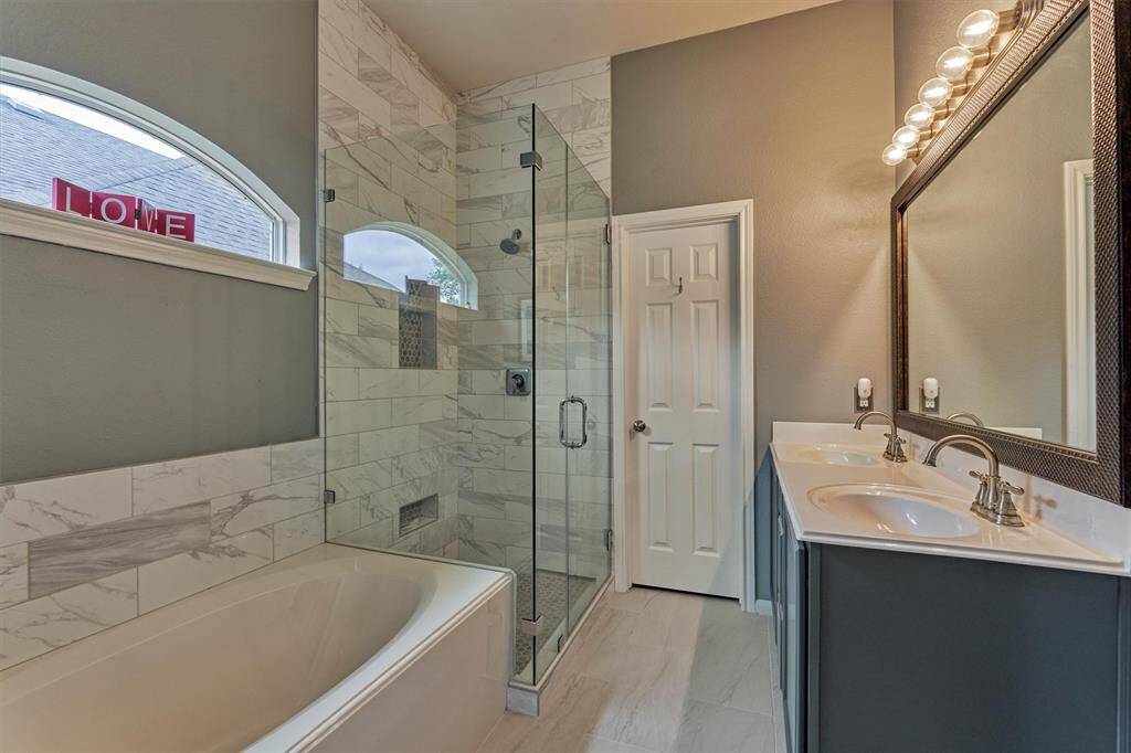 Updated tile surround and frameless shower glass enclosure