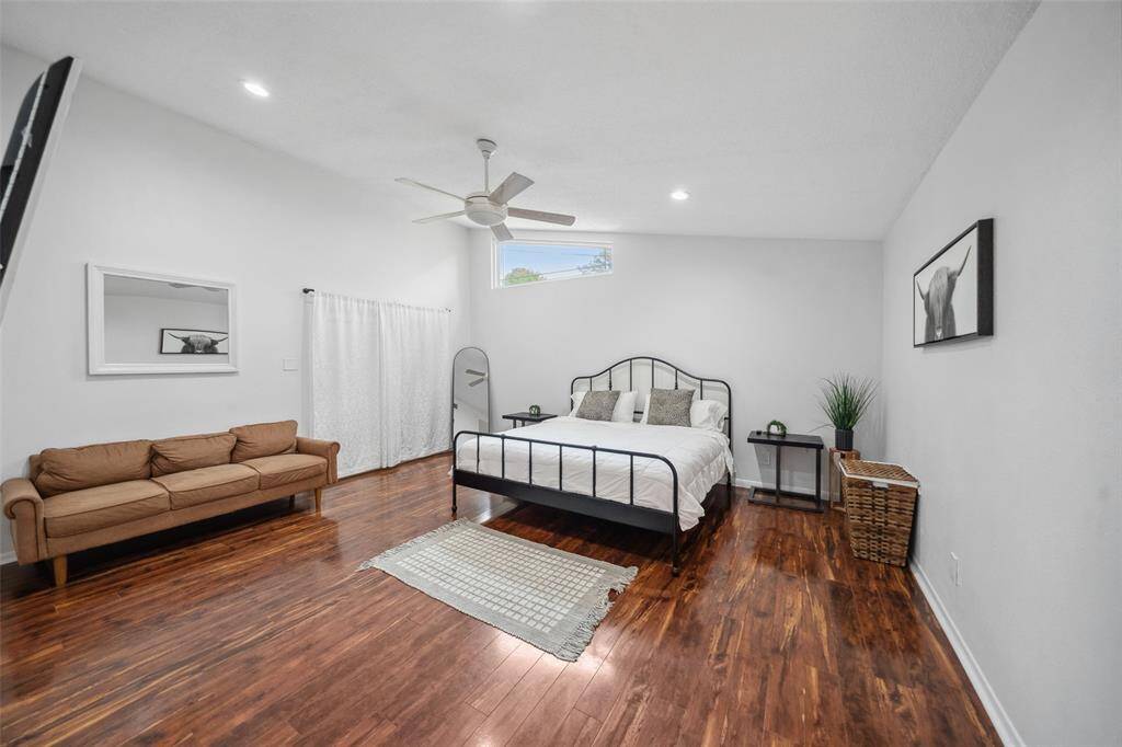 Large primary bedroom with luxury vinyl flooring.