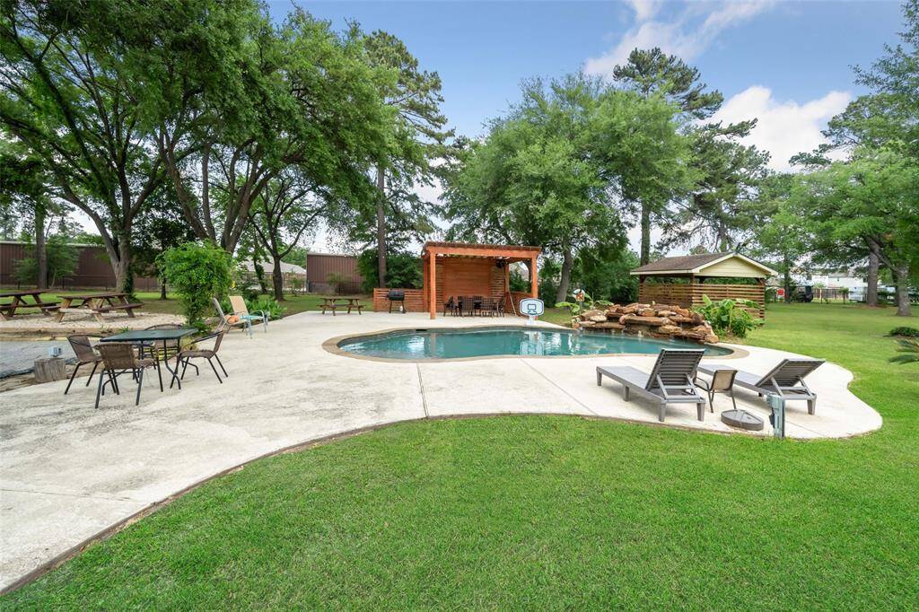 Pool is set-up for entertaining with a newer pergola.
