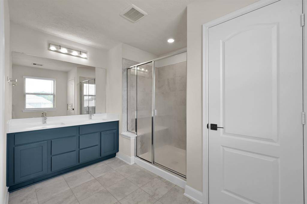 Primary bathroom with oversized shower and double sinks