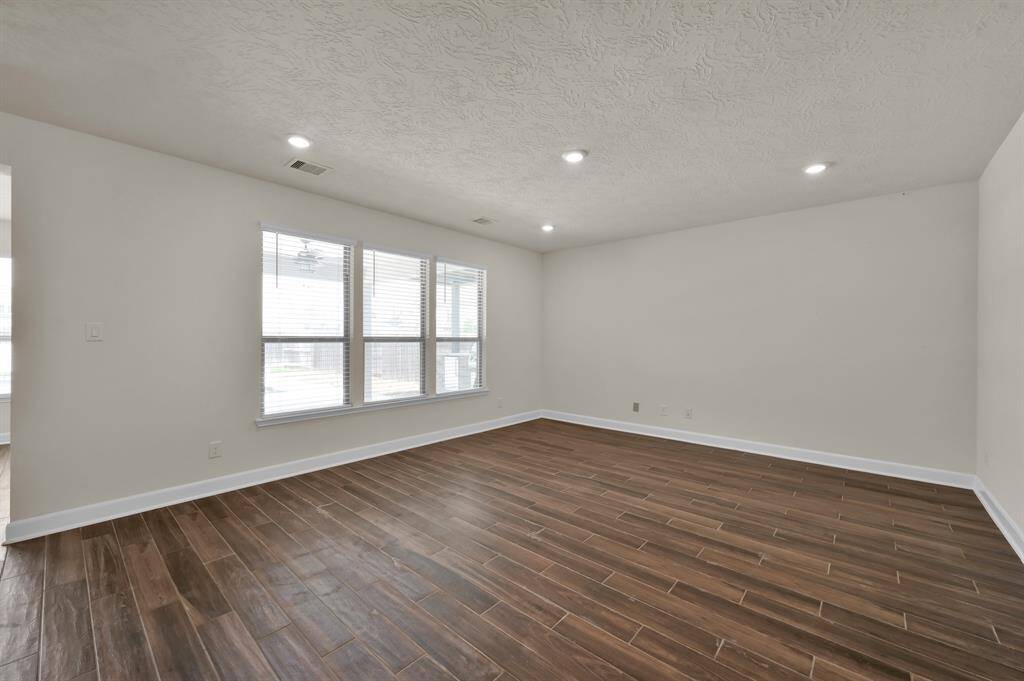 Large living room with wood look tile floors