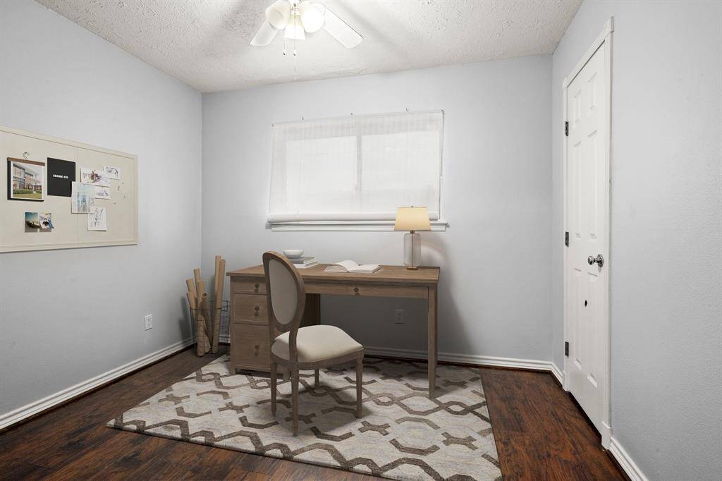 Secondary bedroom has been virtually staged as a home office.