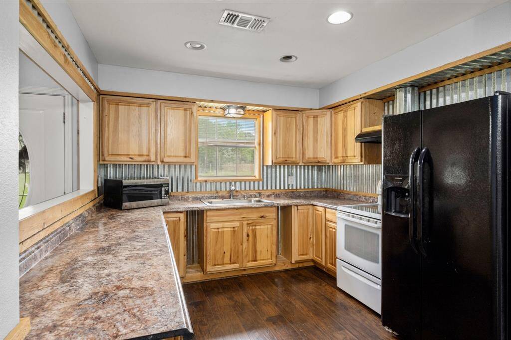 Cute country kitchen is open to the family room.