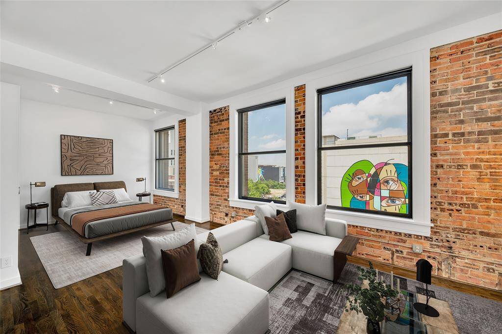 The open loft floor plan makes furniture placement flexible and easy as well as keeps the whole home light and bright. Bathroom and Walk-In Closet to left of Bedroom alcove.   PHOTO VIRTUALLY STAGED.