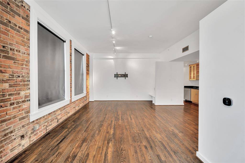 From Bedroom looking into Living ahead and Kitchen at back right. This photo shows the black-out shades lowered, which is great for TV viewing or sleeping!  In front of Kitchen is the perfect place for a Kitchen Island, Dining Table or a combination of both!