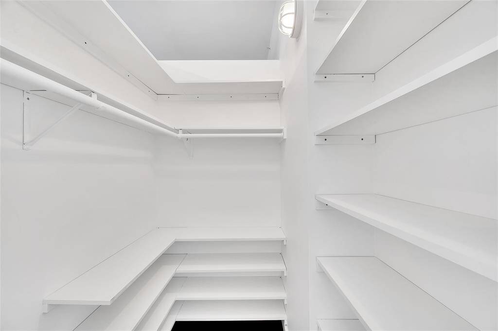 Walk-In Closet has abundant hanging and shelf storage! Note the cool light fixture!  In addition to this closet, the unit comes with an assigned storage cage in building's basement for those larger items or items you don't use everyday!