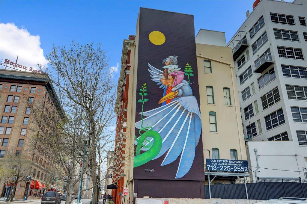 "Sharing The World" by artist Ana Marietta is on ode to Houston's diversity & international influence. One of dozens of commissioned murals added to Downtown's hardscape. Bayou Lofts can be seen on the far left.