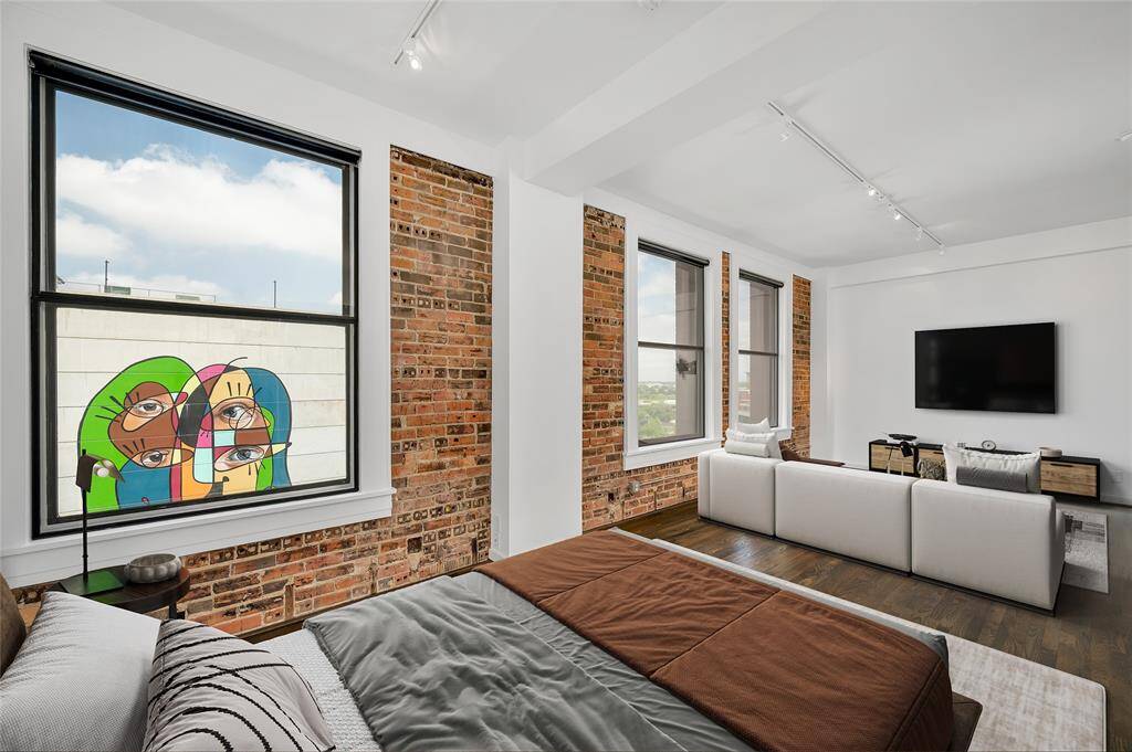 Exposed brick walls, 10ft ceilings, Lutron light switches and white track lighting are other outstanding features. All windows have Magnetite window inserts for noise and energy efficiency as well as black-out shades! PHOTO VIRTUALLY STAGED.