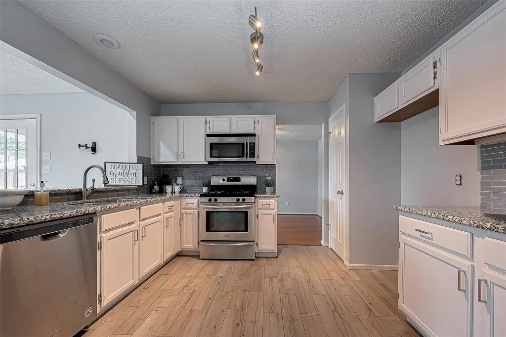 The kitchen is a great space to gather while being available to those in the sun room and also to the Den