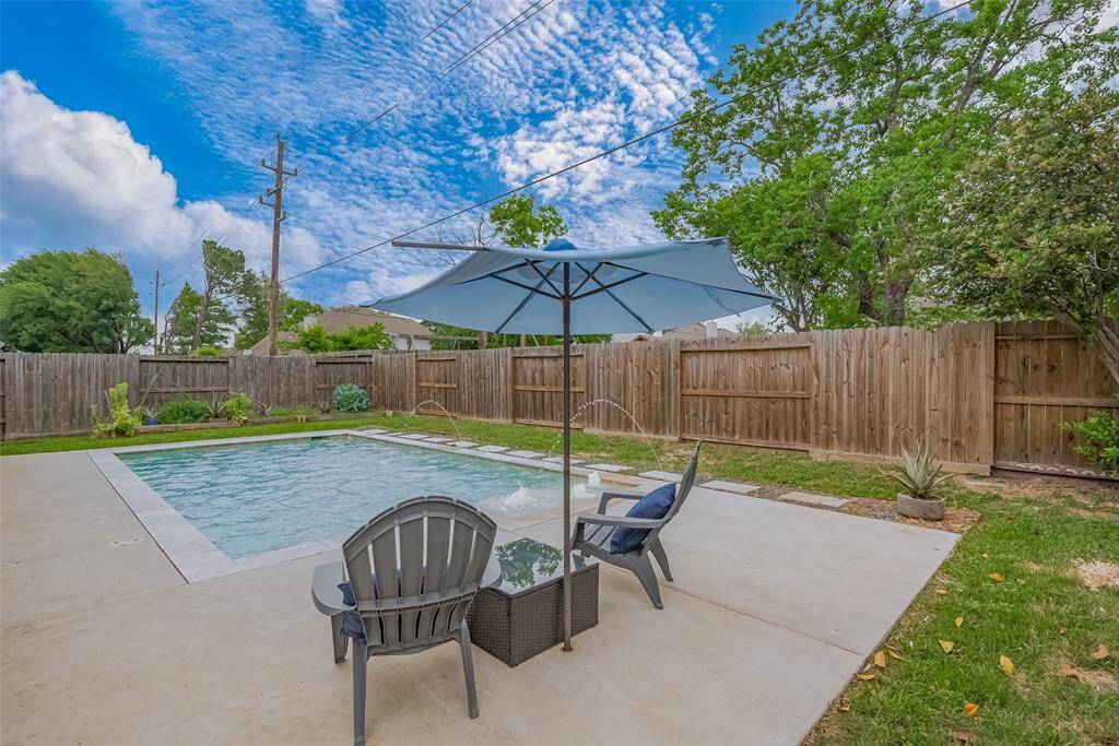 Step into your private backyard retreat featuring a well-maintained mid-size pool—perfect for both relaxation and entertaining