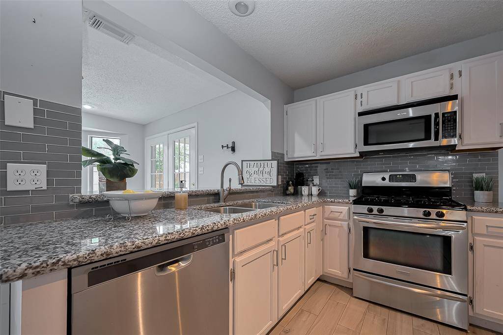 The kitchen is truly the heart of this home, thoughtfully designed with an open layout that seamlessly connects to both the sunroom and the spacious family room.