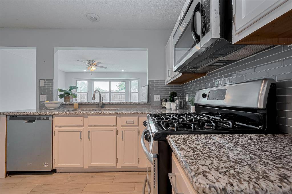 The kitchen is truly the heart of this home, thoughtfully designed with an open layout that seamlessly connects to both the sunroom and the spacious family room.