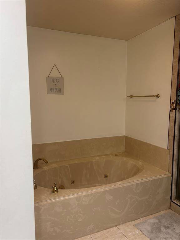 Relax in the primary bathroom's luxurious soaking tub or enjoy the modern shower.