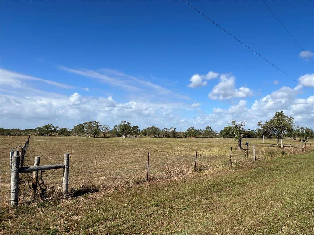 Vantage point from far-left front corner of this Beautiful fully fenced, AG EXEMPT 5-ACRE lot with over 720 Linear feet of road frontage on S Redfish Dr and another 213 more Road Frontage on Butler St. Prime for subdividing and/or building your DREAM HOME.