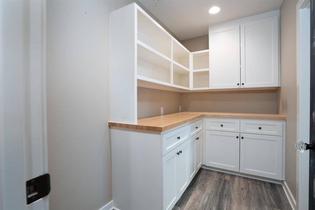 Walk-in pantry has a butcher block counter.