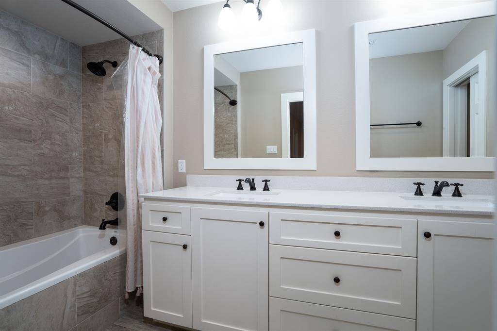 Updated full bath with double sinks and oversized tub/shower.