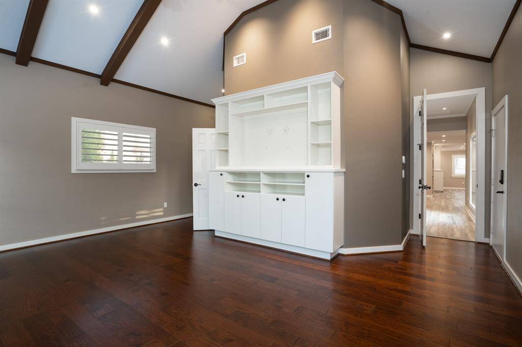 Extras include the wood flooring, built-in speakers, custom entertainment center and split floorplan.