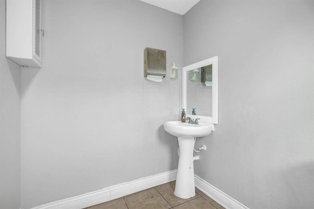 Bathroom and sink inside beauty salon (Unit #1).