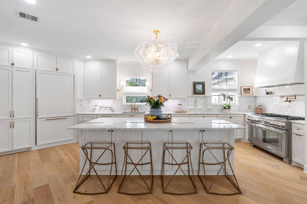 Completely remodeled! This fantastic kitchen features a Thermador appliance package, marble counters and backsplash.