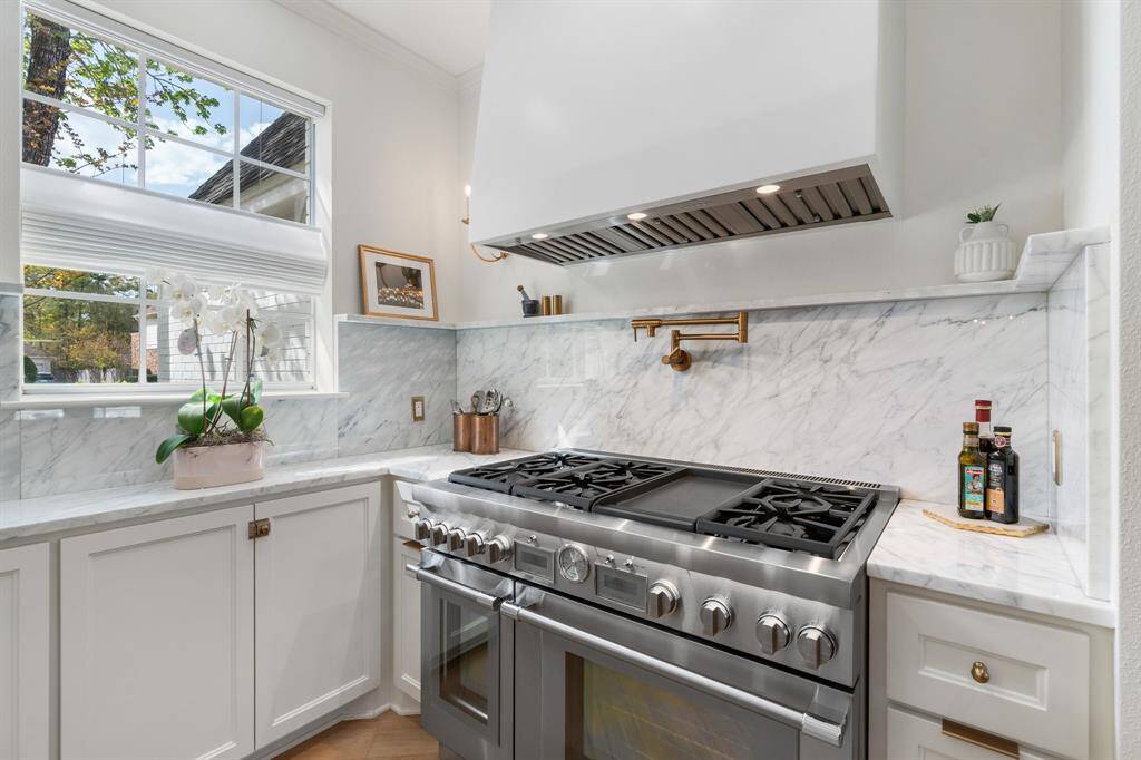 The kitchen was extended to allow for plenty of natural light, work space and storage. A display shelf and pot filler were added conveniences.