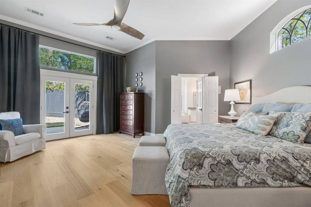 With private access to the patio, Winsome Grey walls further compliment the white oak flooring in this spacious primary retreat.